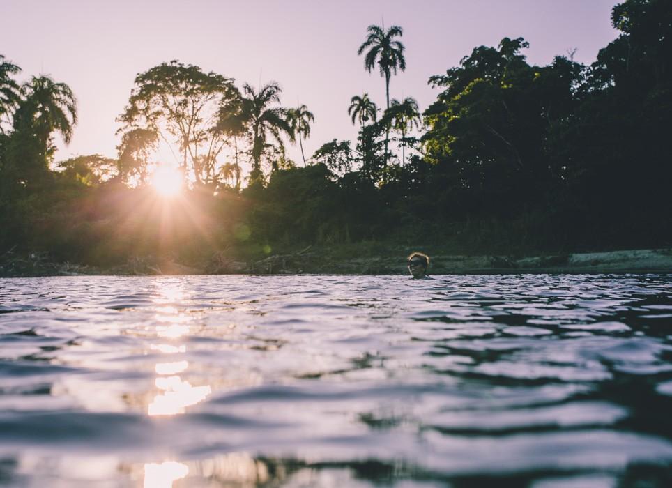A woman swimming in Cabarete, Dominican Republic at sunset.