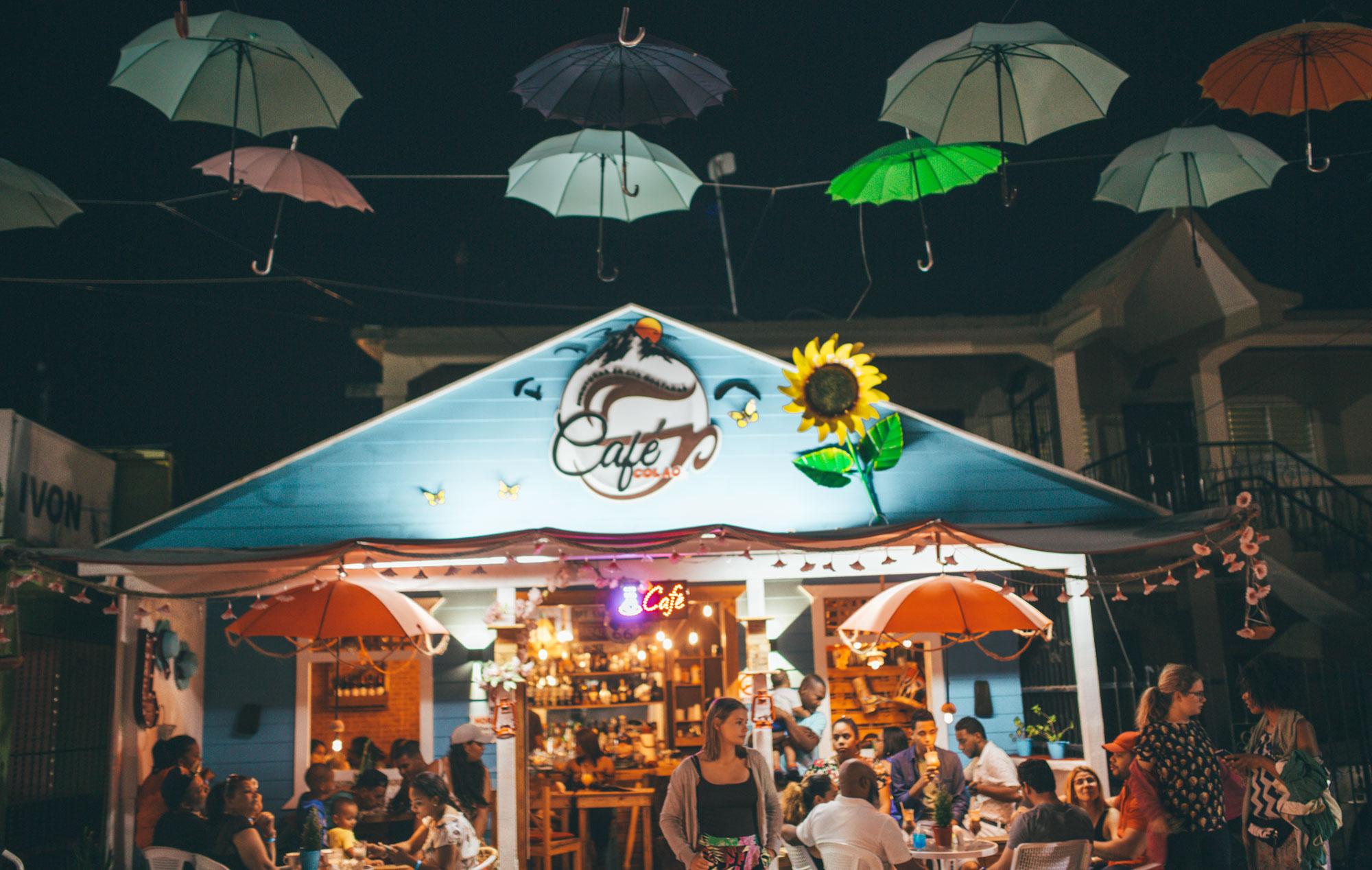 The outside of a cafe in Jarabacoa decorated with umbrellas.