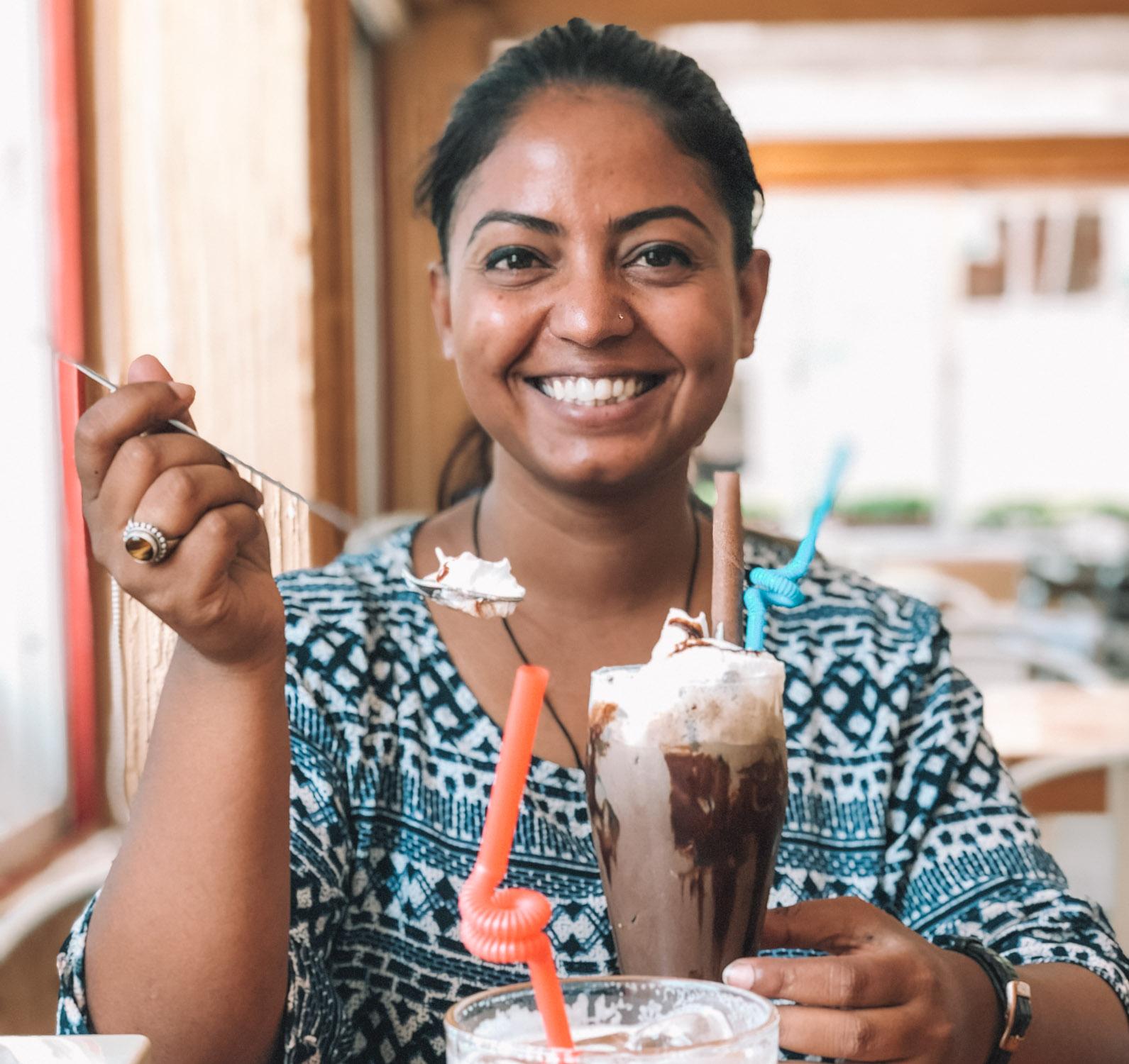 A woman eating dessert; royal mountain travel.