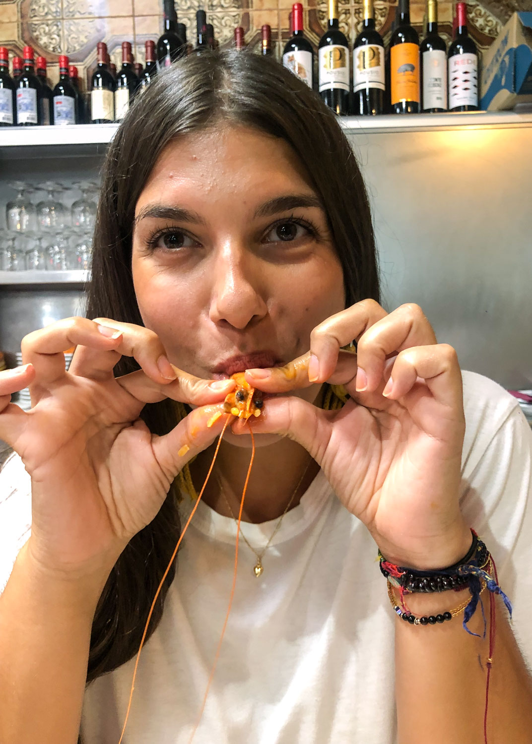 A woman eating a shrimp dish in Lisbon
