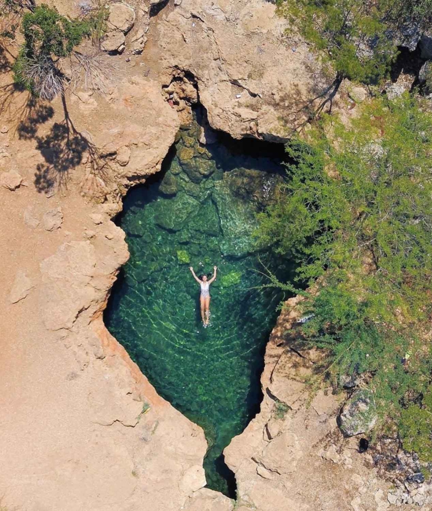 a natural pool enclosed by rocks and cacti in dominican republic
