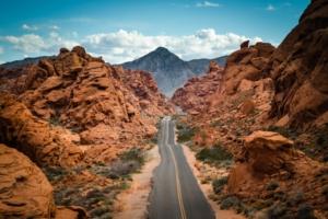 A road between the rocky mountains of Valley of Fire, one of the day trips from Las Vegas.