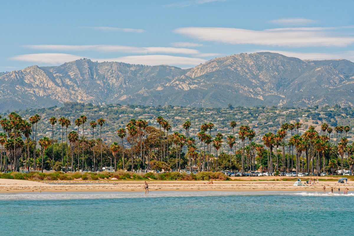 Santa Barbara beach and ocean view with palm trees and mountains in the background.