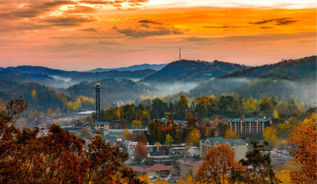 a view of the town of gatlinburg from afar with the mountain backdrop
