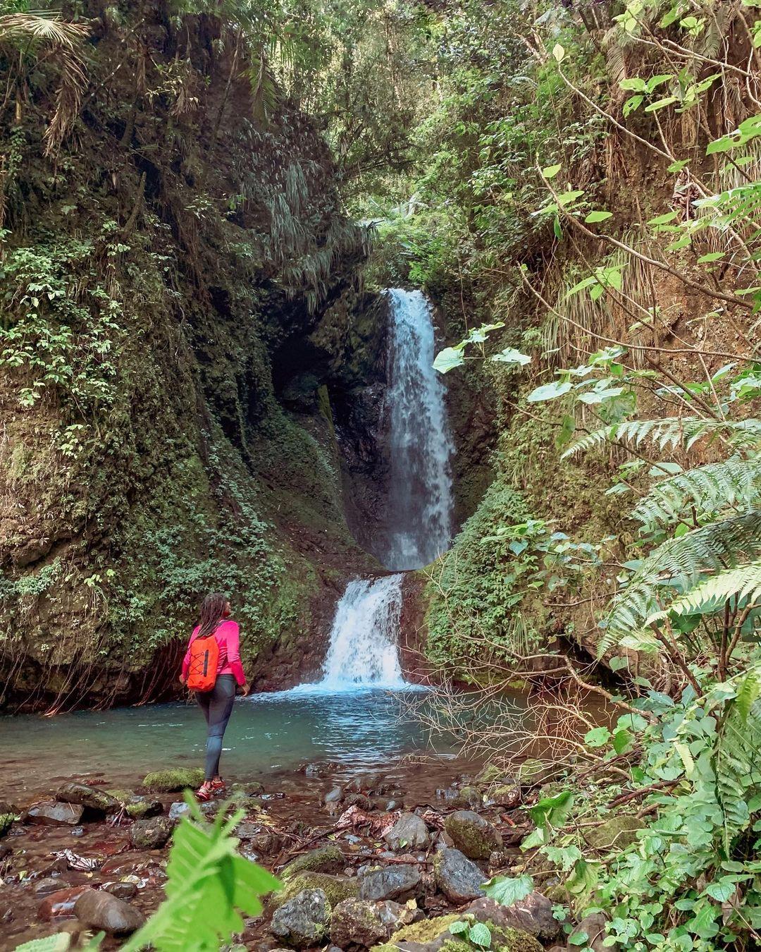 A woman hiking at Toro Flaco Waterfall.