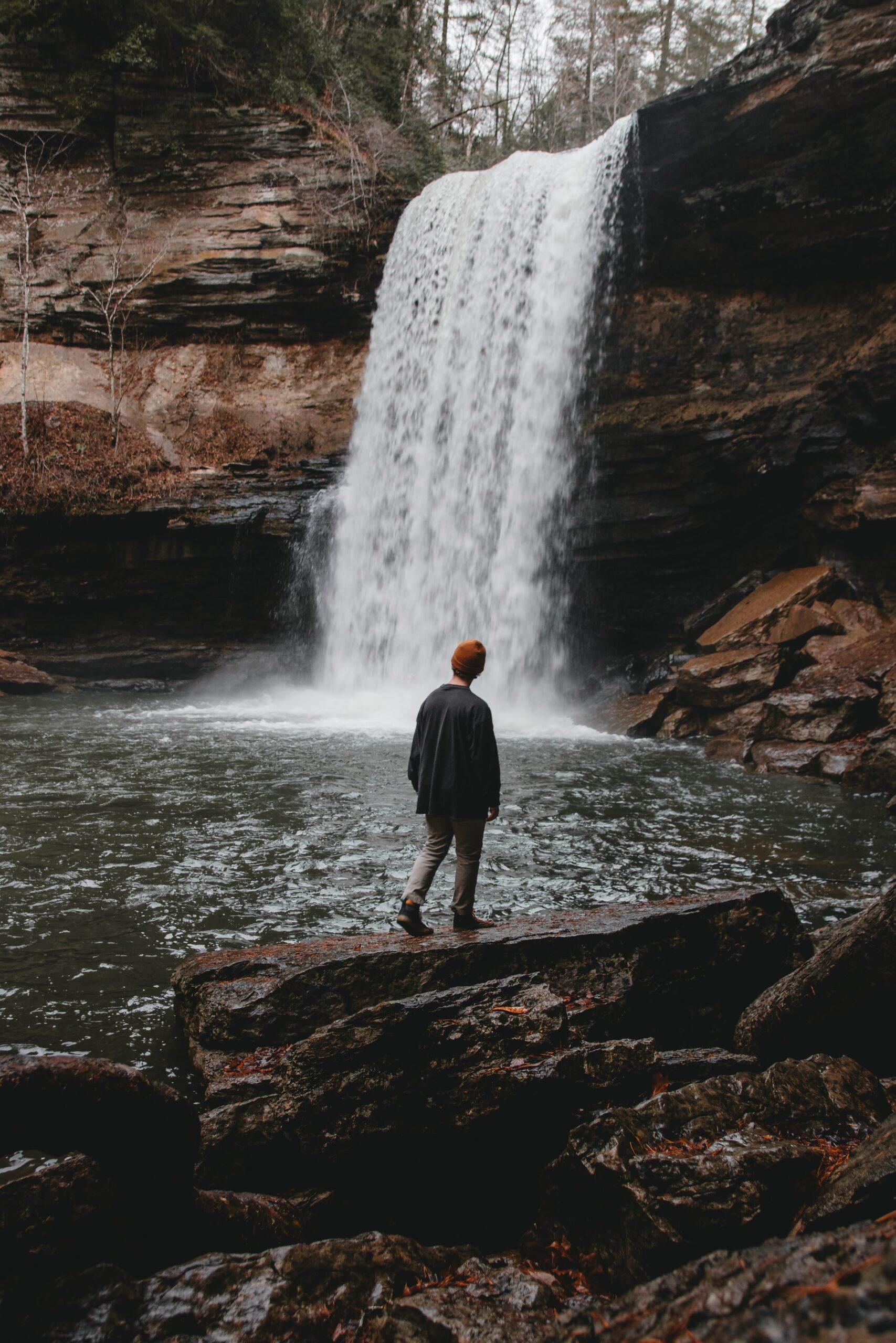 a tall waterfall with a swimming hole in tennessee