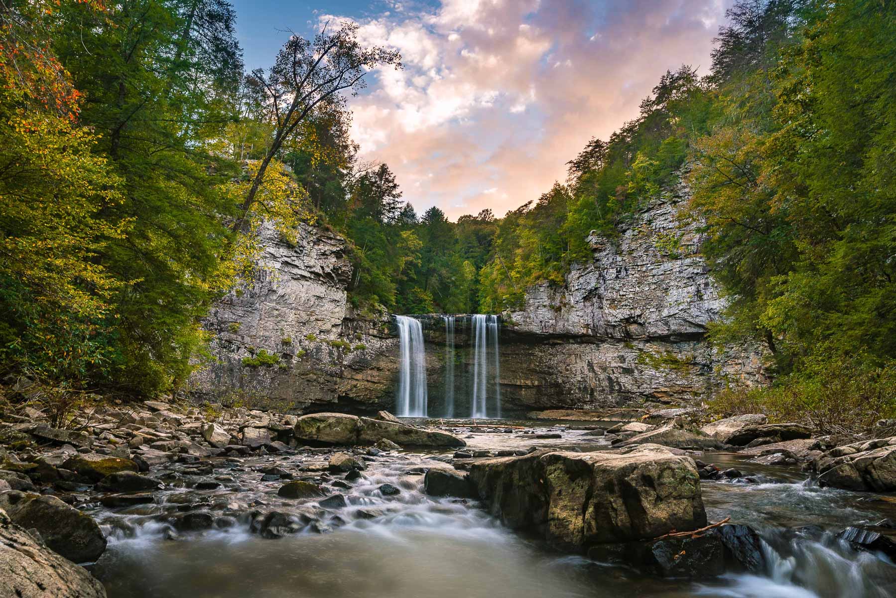 a waterfall during sunset