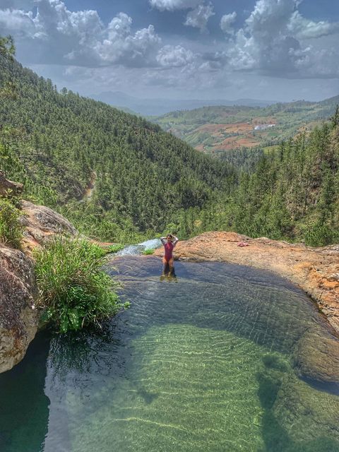 A woman at Piscina Aguas Blancas natural pool in Constanza, Jarabacoa.