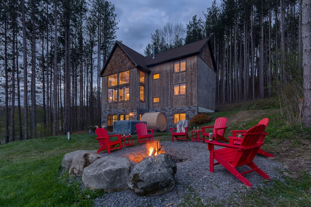 A chalet in the woods with a bonfire area, one of the best cabin rentals in Upstate New York.