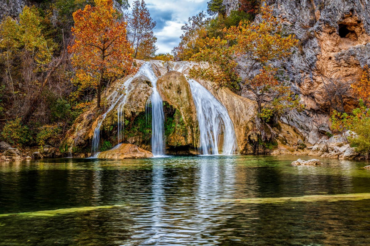 Waterfalls cascading on a natural swimming pool in fall.