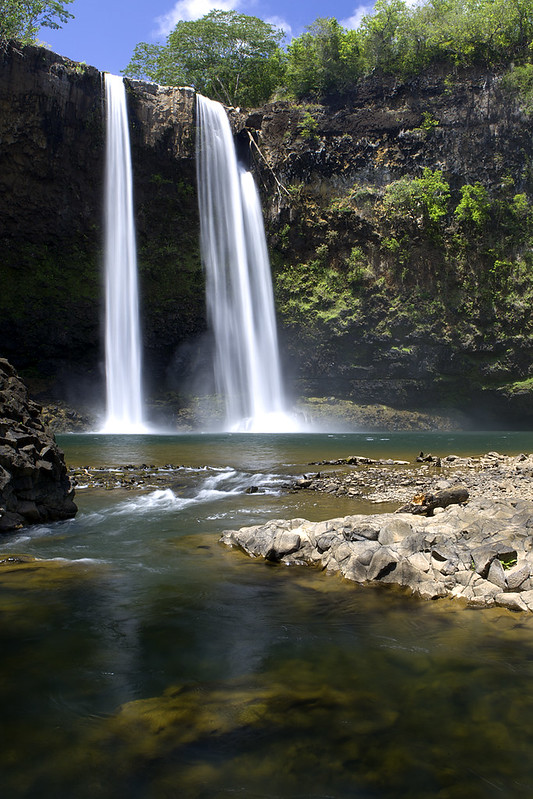 Multiple waterfalls cascading to a river.