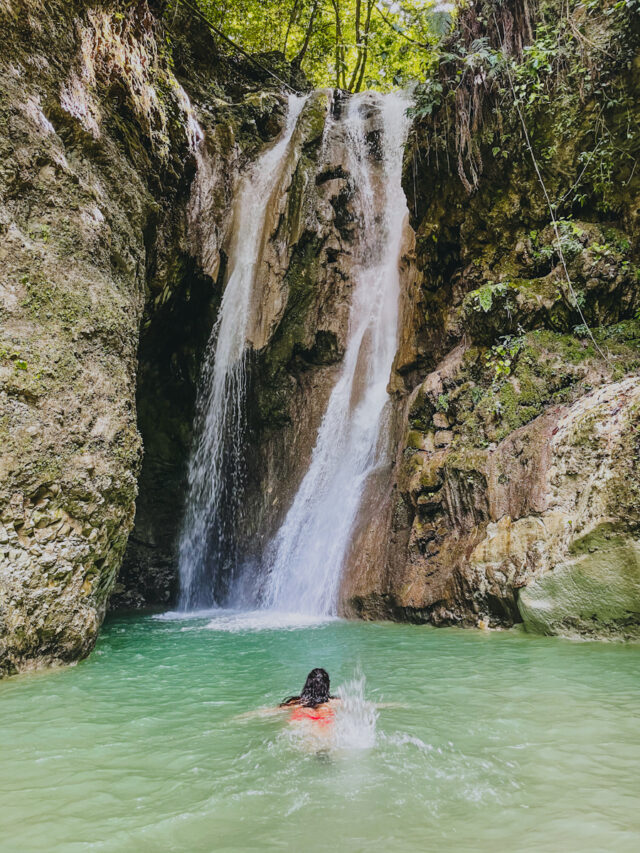 A woman swimming at La Rejoya Waterfall natural pool.