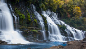 a cascade of waterfalls with blue water