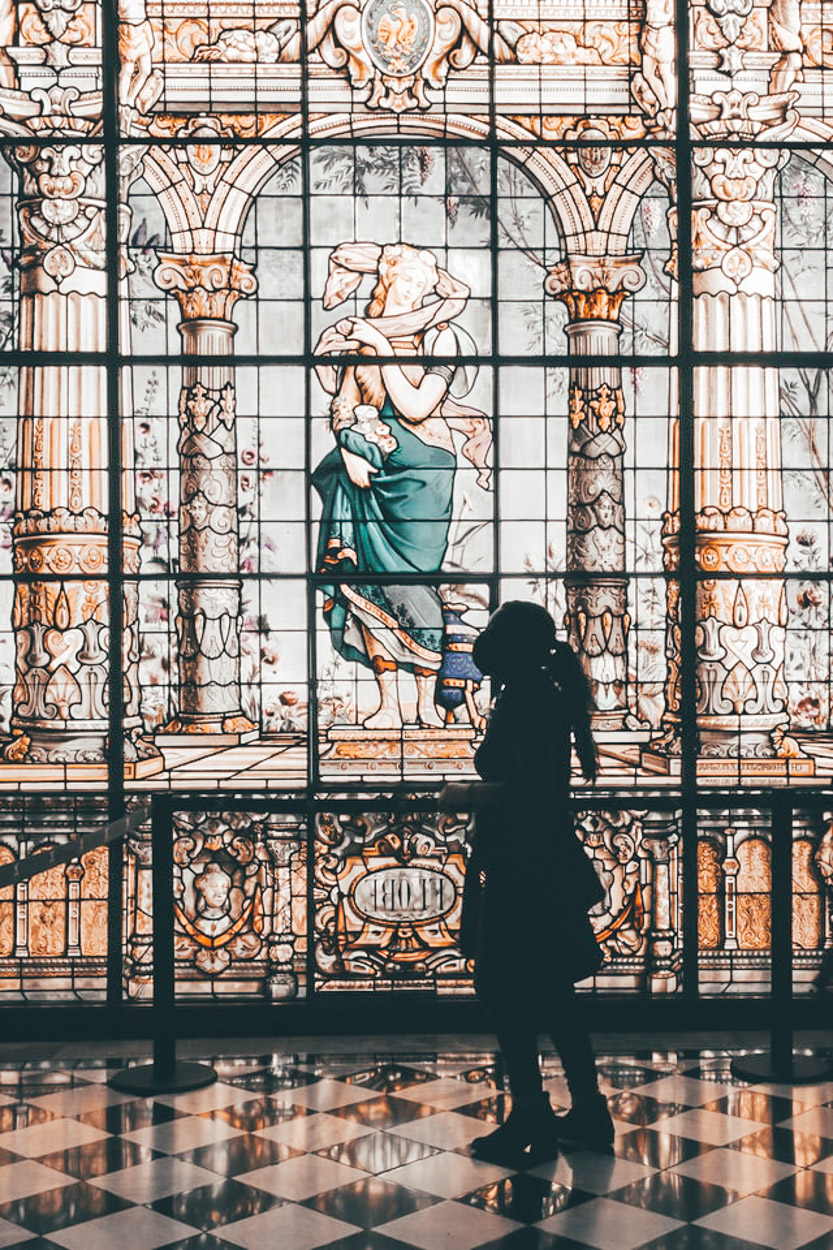 A silhouette of a woman beside a wall art.