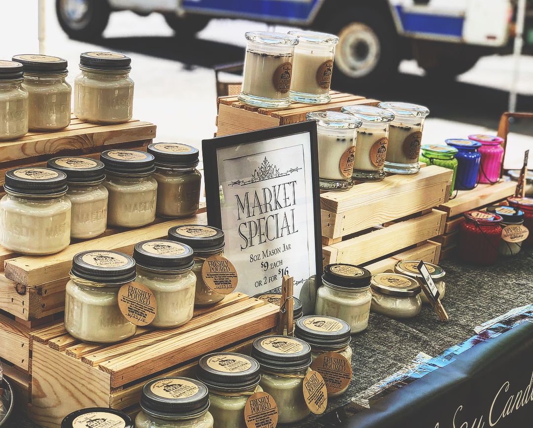 Stand at Farmer's Market with Mason jars of hand made products.