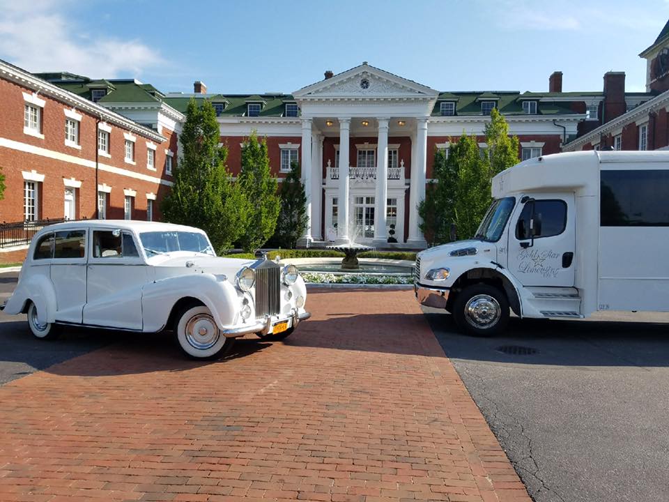 Limousine and truck in front of the beautiful building that looks like a temple.