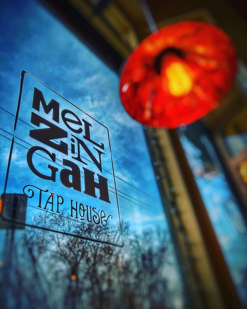Window of the restaurant with restaurant's logo.