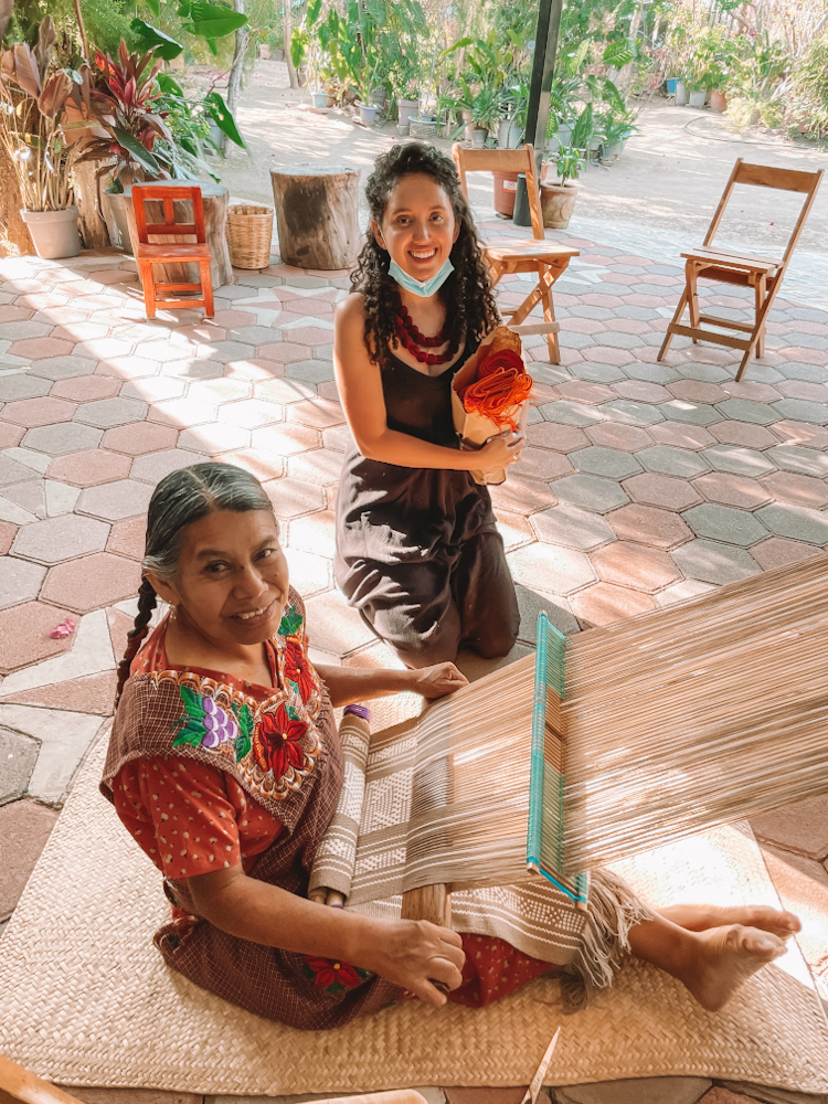 A woman tourist and a woman who weaves textiles in Oaxaca, Mexico.