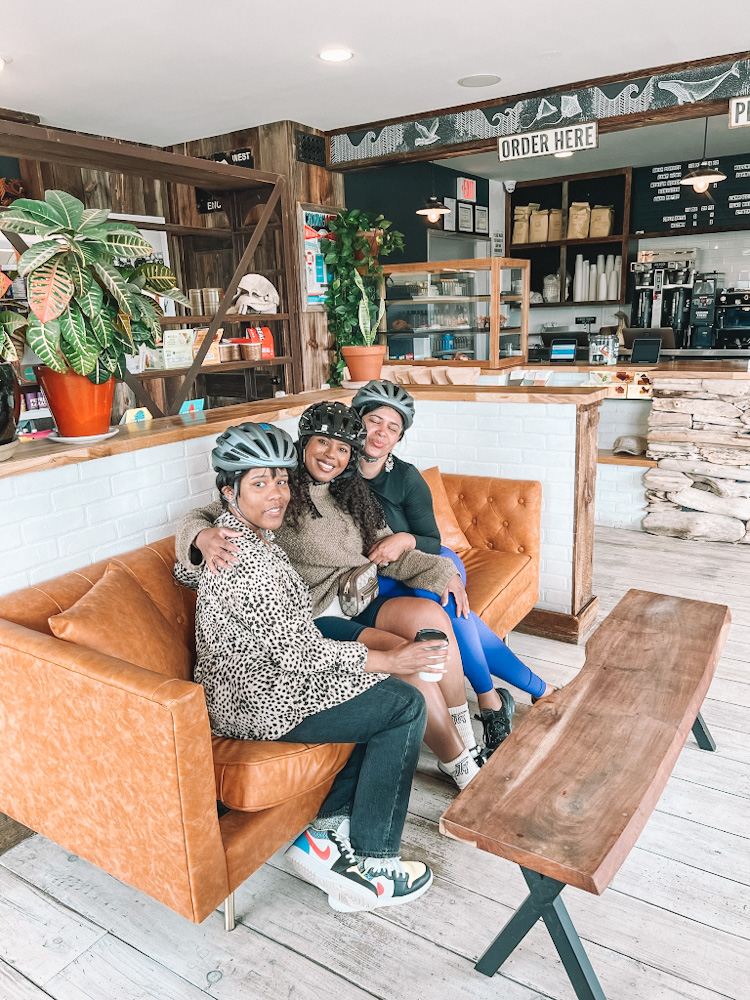 Three women sitting on a couch inside the cafe in Montauk.