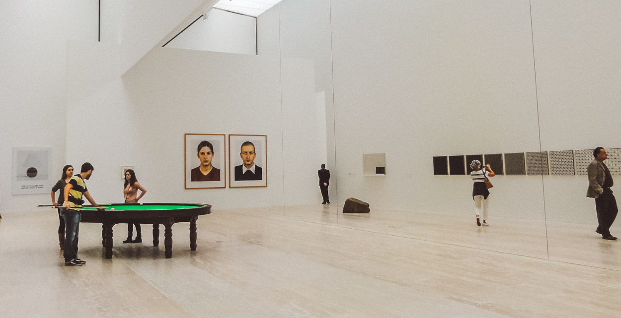 People perusing artworks inside the Jumex Museum.