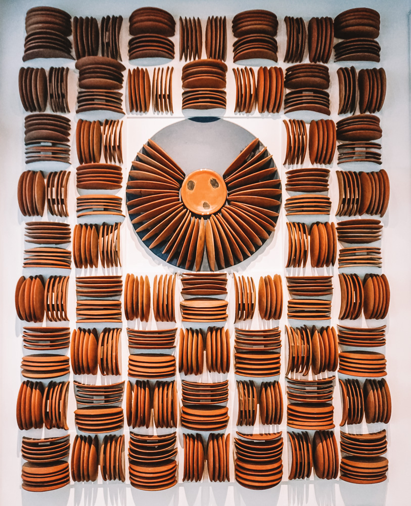 Art installation of plate-like objects at Museum of Popular Art.