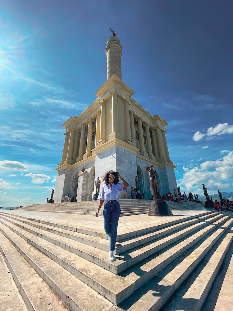 A woman standing in front of a monument building. inSantiagi, Dominican Republic.