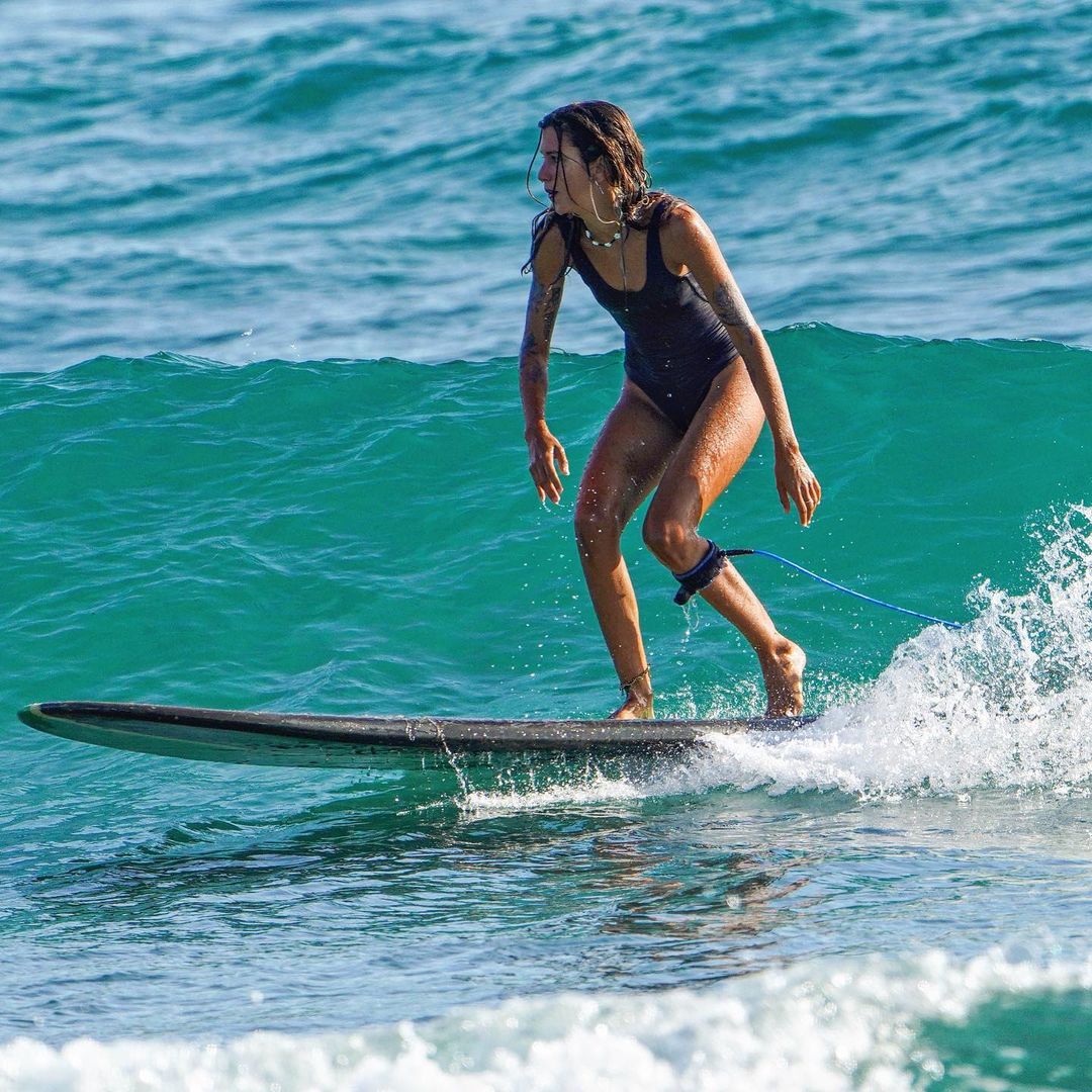 A woman surfing at Encuentro Beach.