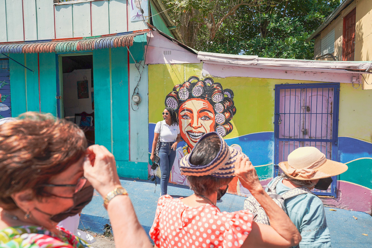 People visiting Los Pepines Local Mural, one of the things to do in Santiago, Dominican Republic.