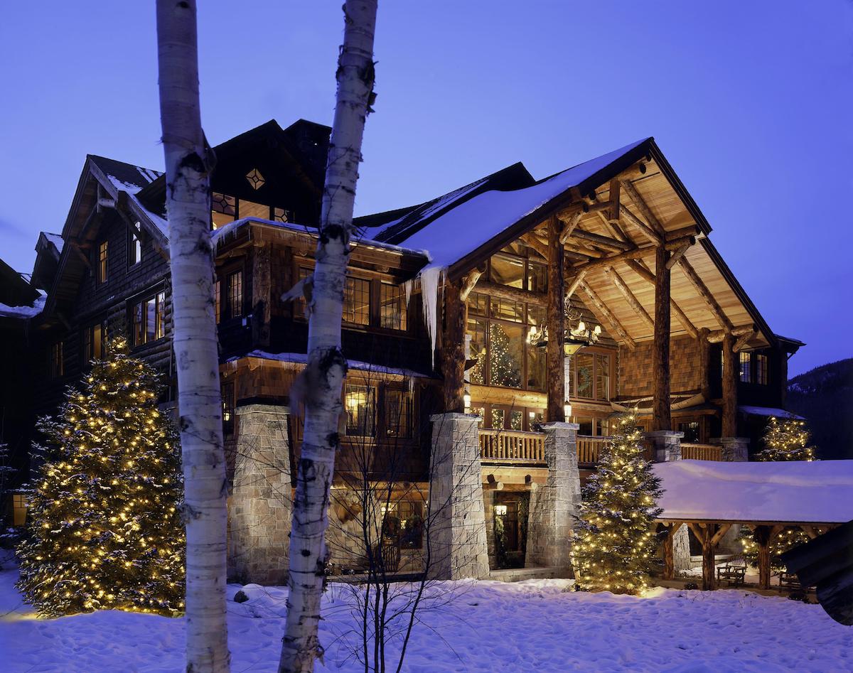 The outside of a luxury lodge in winter.