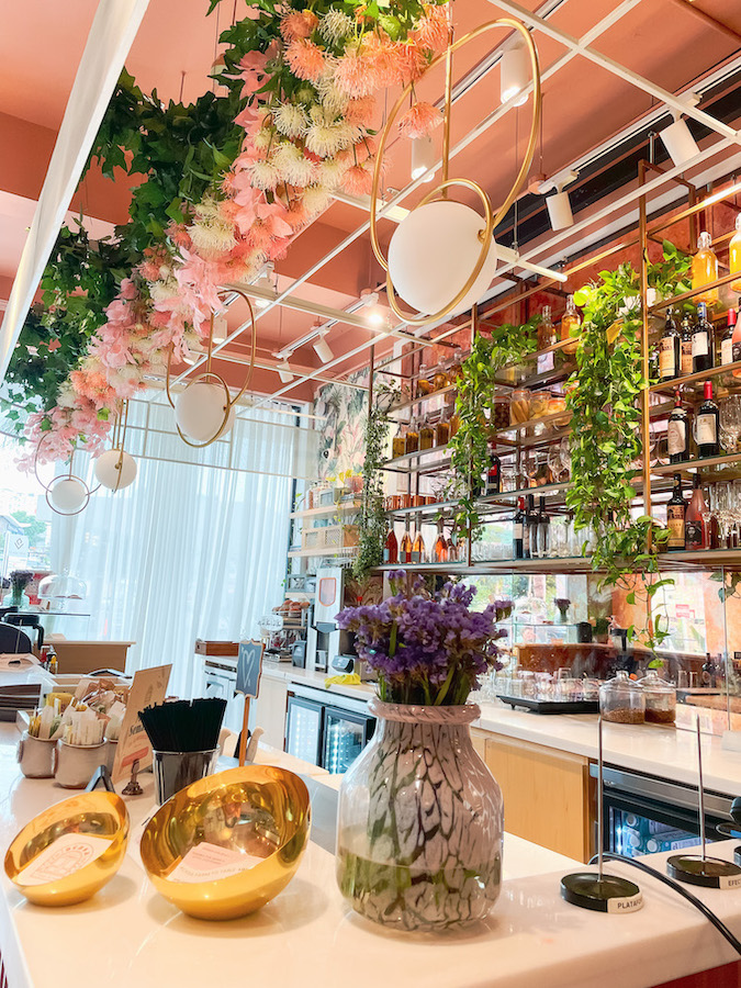 Cafe counters decorated with plants and flowers.