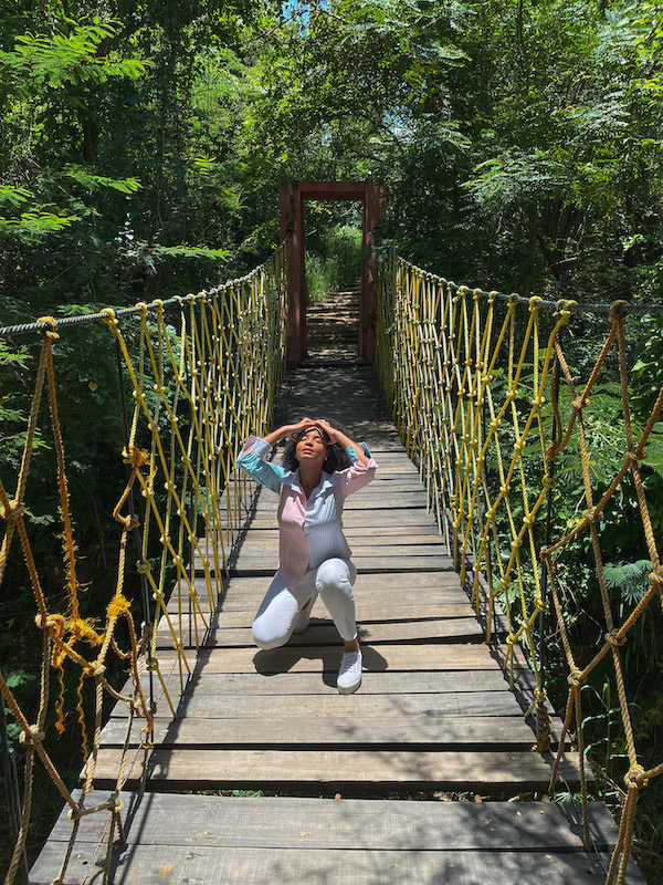 A woman at a bridge at Jardín Botánico de Santiago.