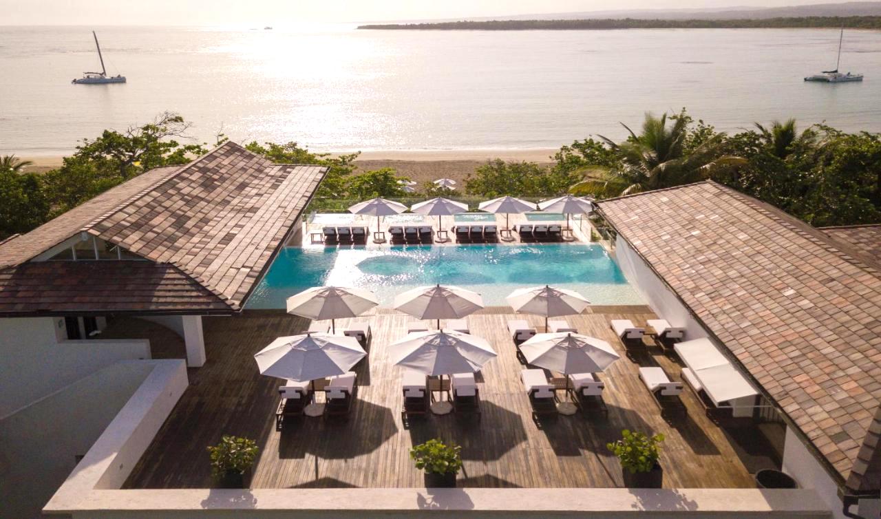 An aerial view of a beach side resort with an outdoor swimming pool in the Dominican Republic.