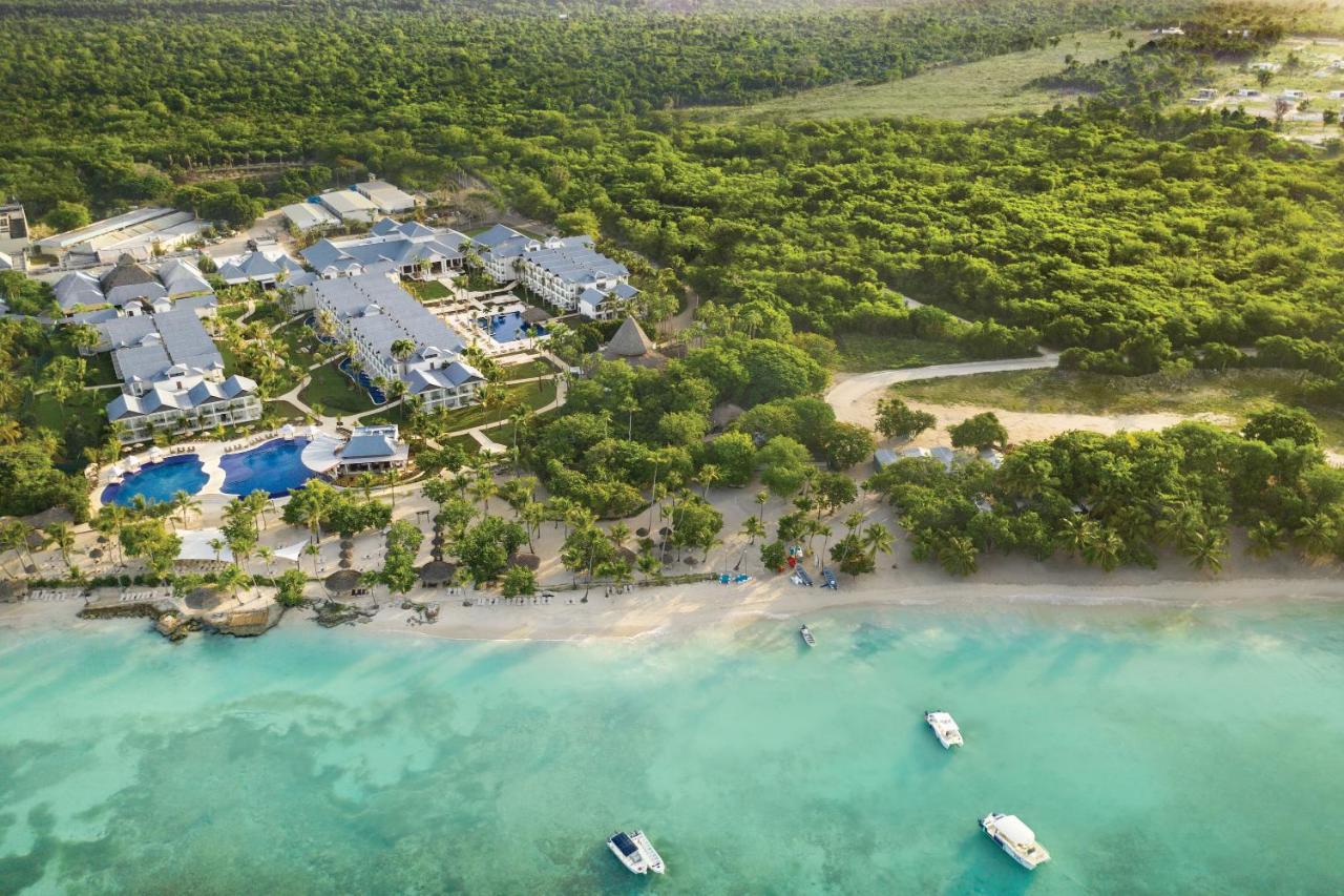 An aerial view of a resort surrounded by the sea and trees in La Romana, Dominican Republic.