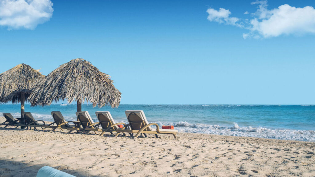 Huts and chairs at the beach by the sea in the Dominican Republic.