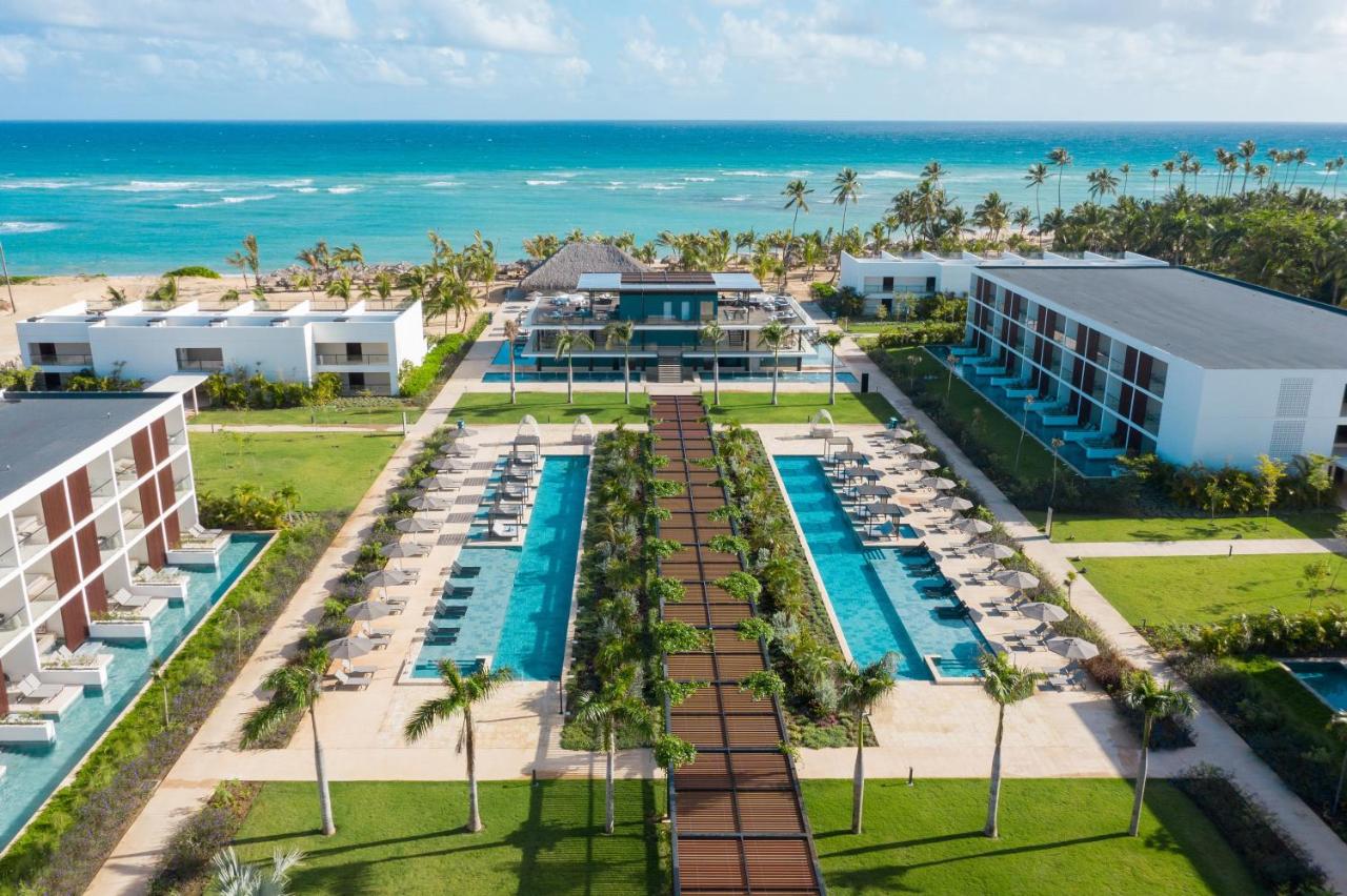 An aerial view of a beachfront resort with outdoor swimming pool in the Dominican Republic.
