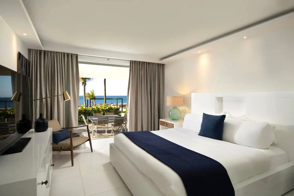 A bedroom with furniture in one of the best resorts in the Dominican Republic.