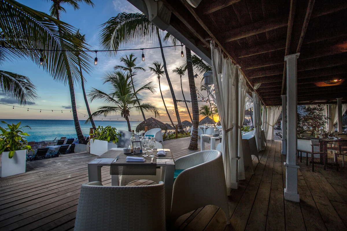 An outdoor dining area by the beach at a resort in La Romana, Dominican Republic.