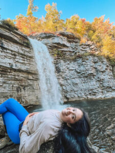 Woman lying down on a rock near Awosting Falls.