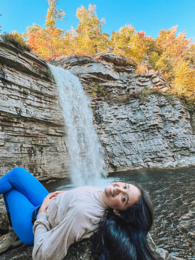 Woman lying down on a rock near Awosting Falls.