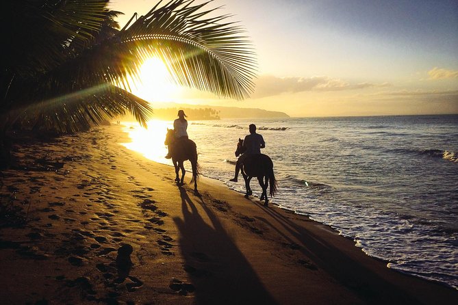 Two people horseback riding at a beach, one of the things to do in Punta Cana.