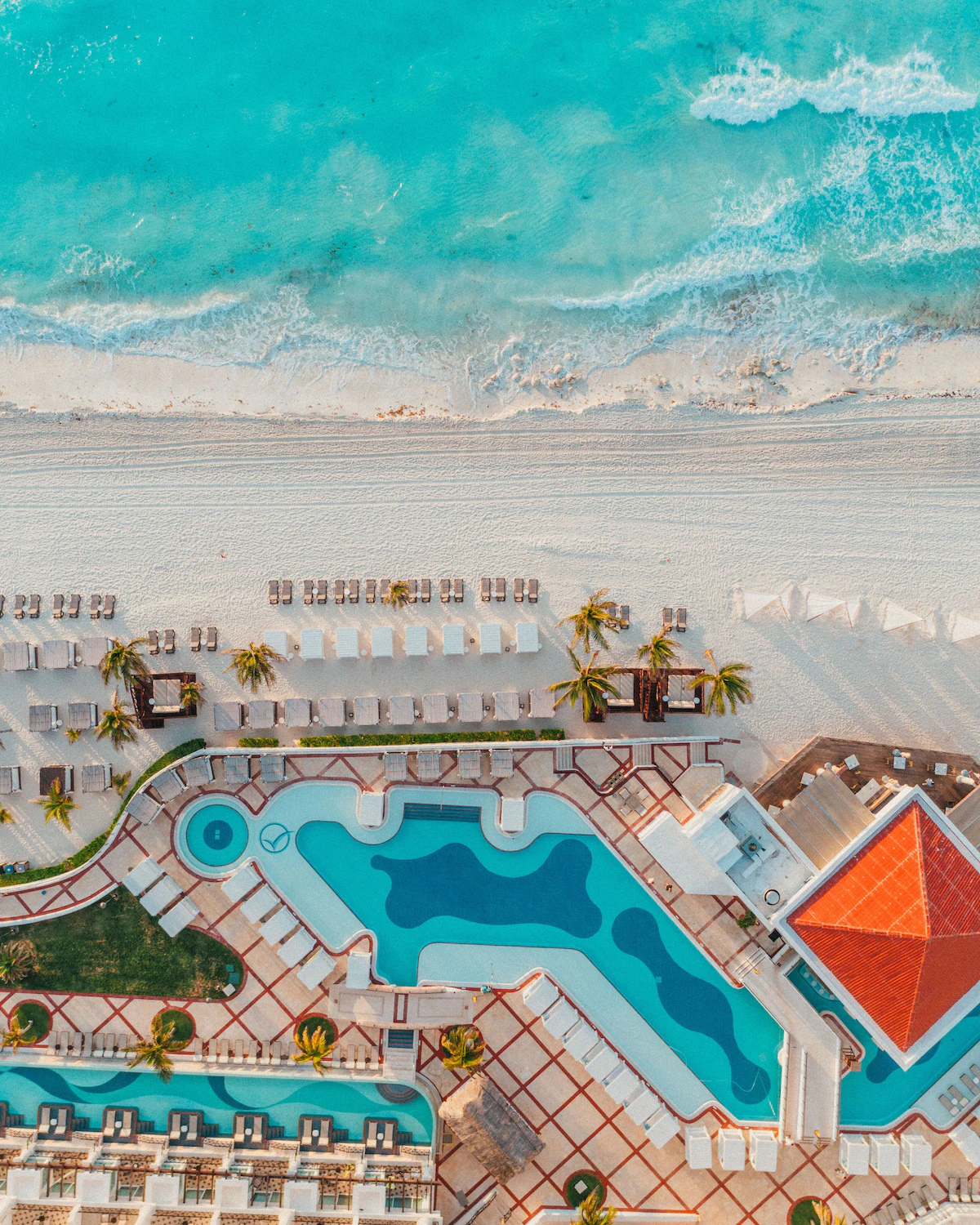 A bird's eye view of a Dominican Republic resort's beach and swimming pool area.