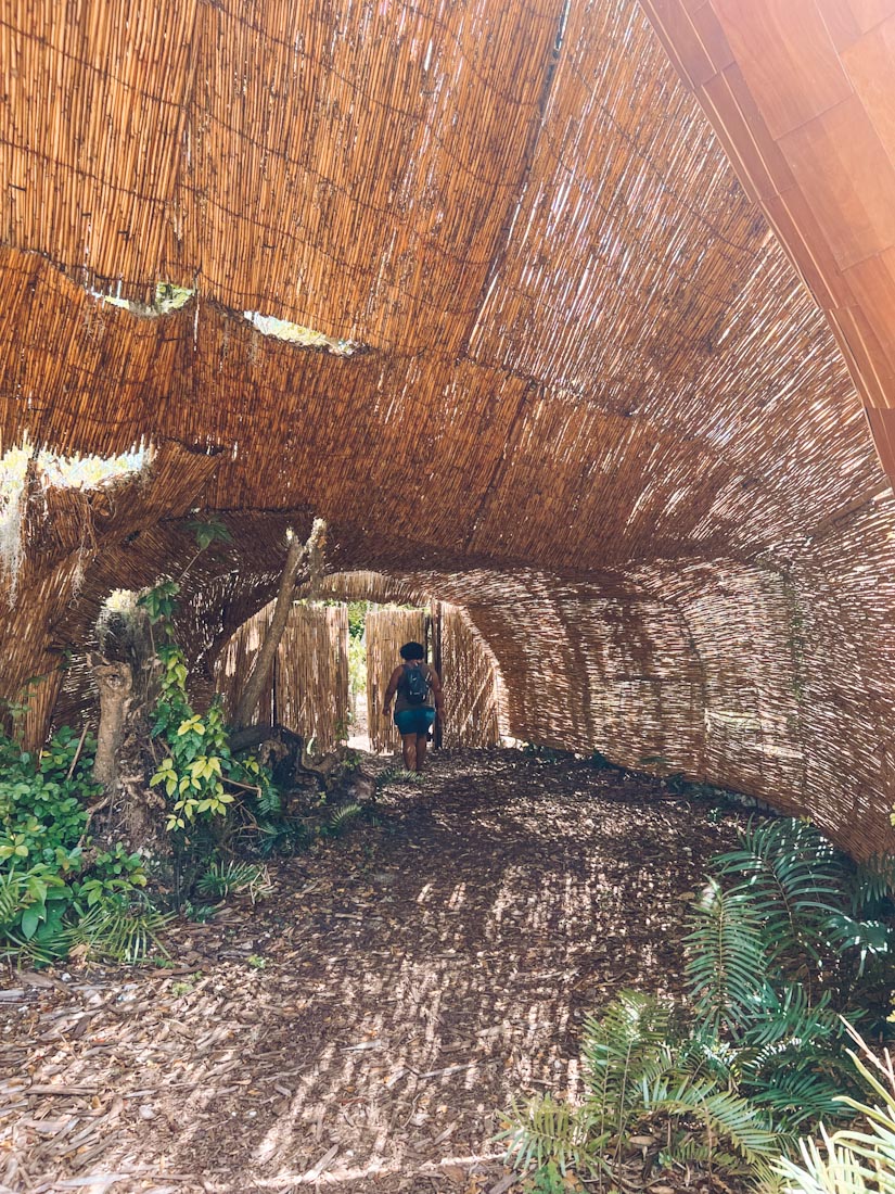 A woman walking at the entrance of Indigenous Eyes Ecological Reserve.