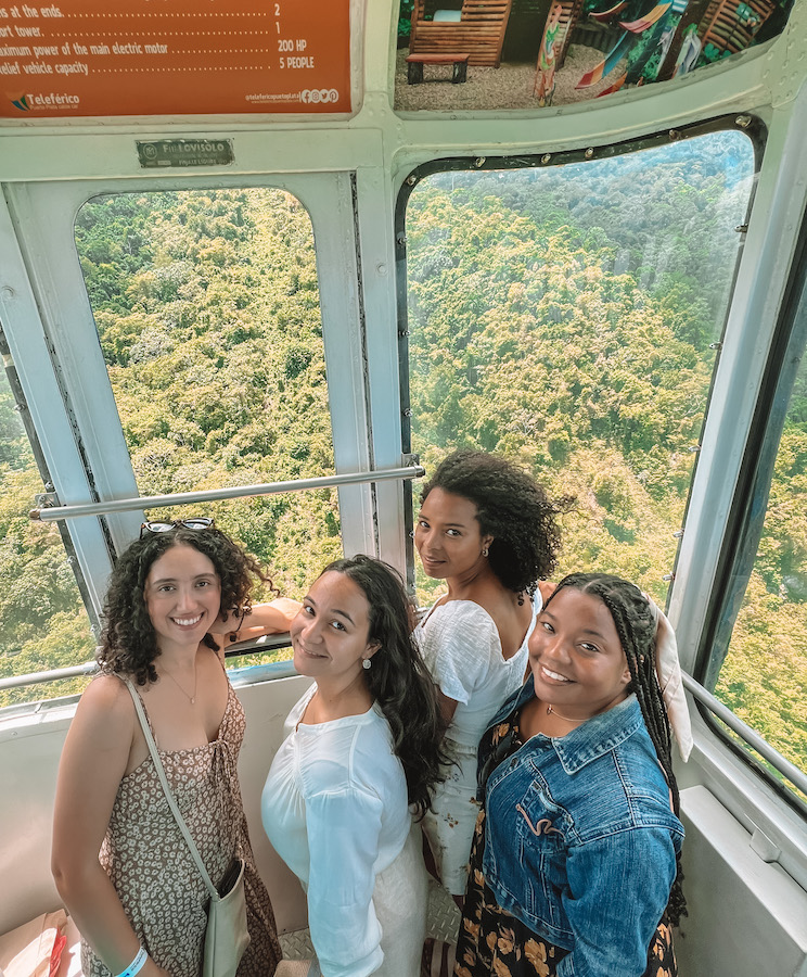 Four women riding a cable car, one. ofthe things to do in Puerto Plata, Dominican Republic.