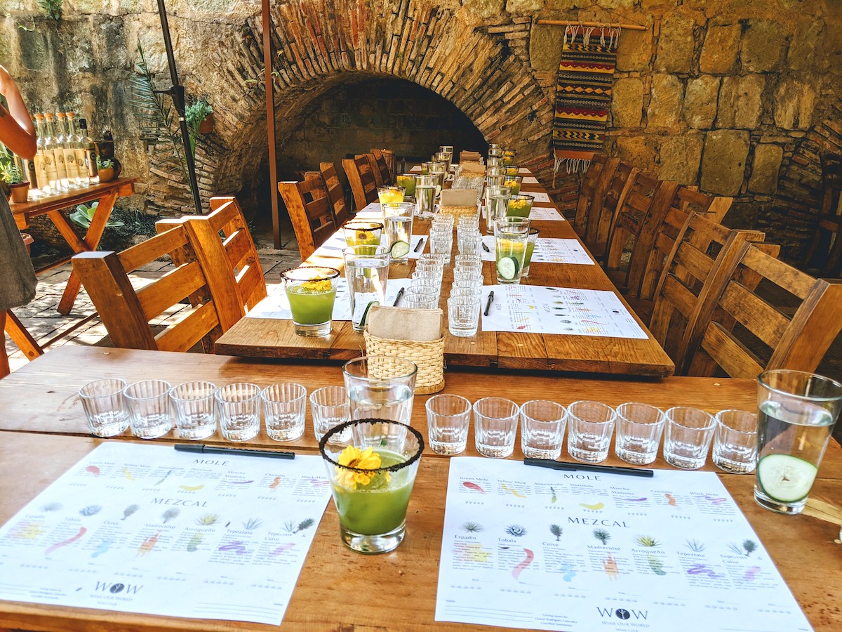 A table prepared with glasses of mole and mezcal.