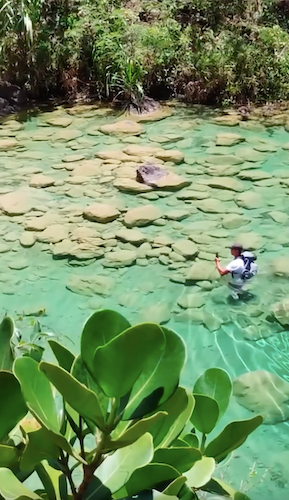 A person taking pictures at Charco dos Aguas waters.