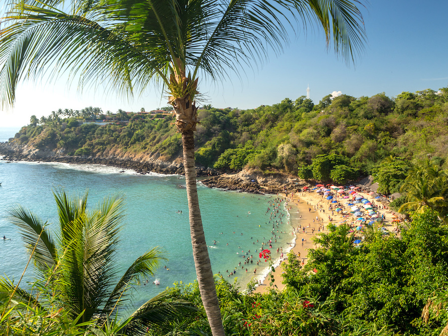 Puerto Escondido beach coast surrounded by people.