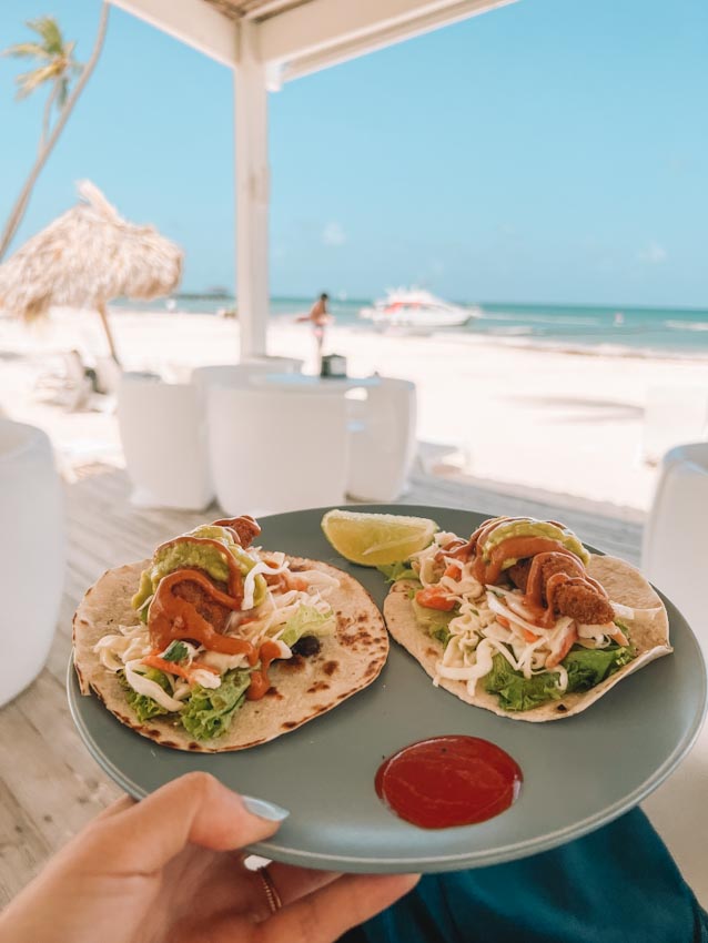 Plate of food at an outdoor dining area by the beach in Punta Cana, Dominican Republic.