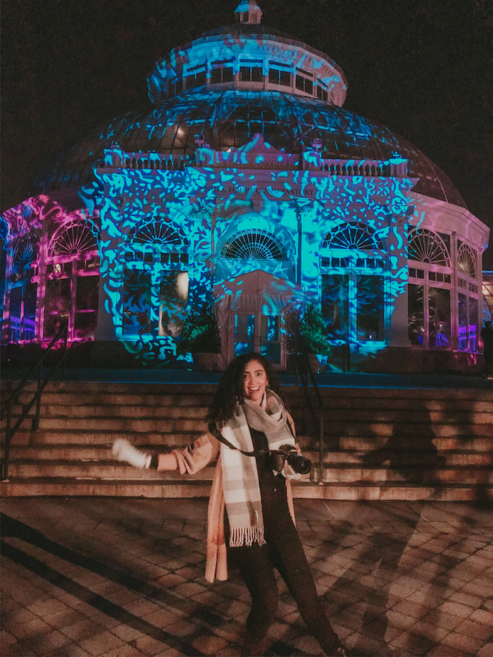 A woman at the New York City in December Botanical Garden’s Glow and Holiday Train Show