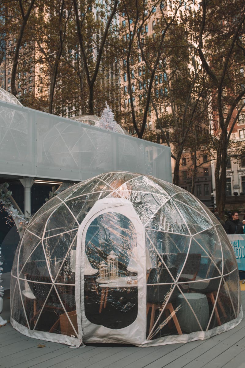 A transparent, igloo-shaped tent at Bryant Park Winter Village