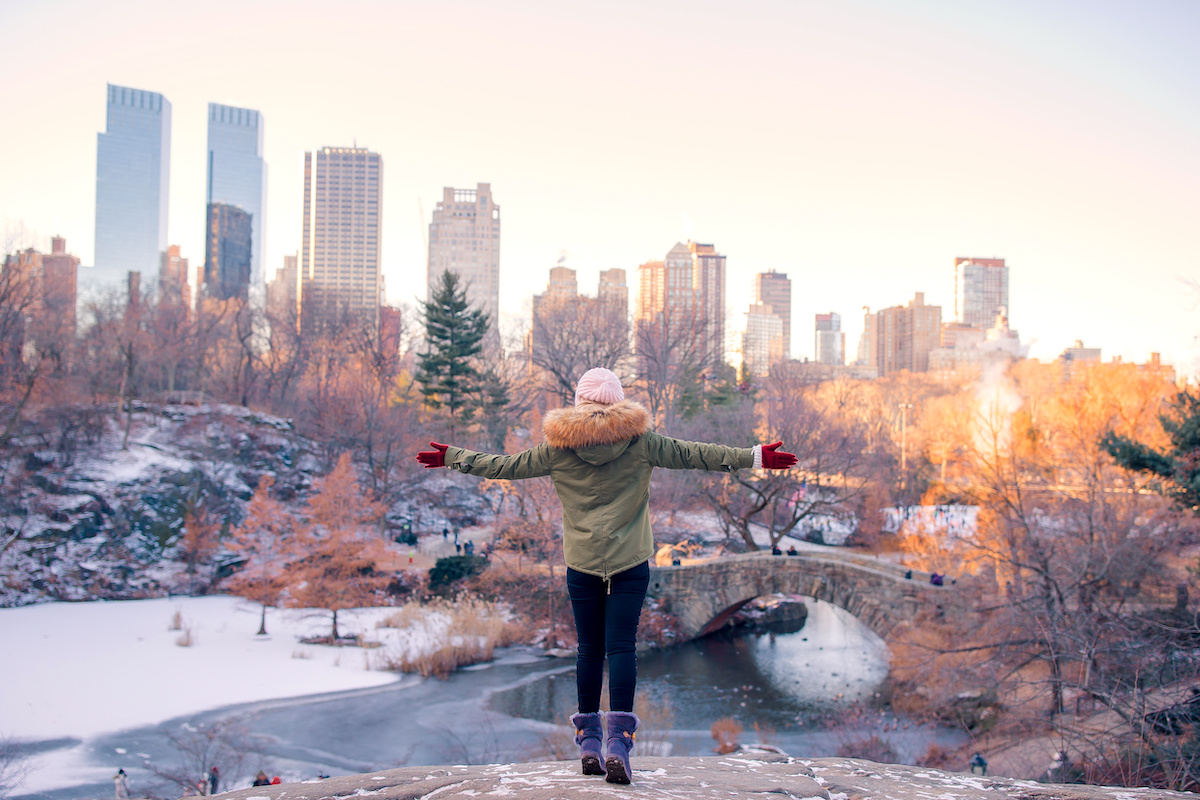 A woman dressed in winter clothes at a park in NYC in December